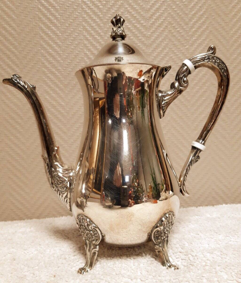 Silver-plated coffee and tea service including a coffee pot, a teapot, and a sugar bowl.