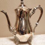 Silver-plated coffee and tea service including a coffee pot, a teapot, and a sugar bowl.