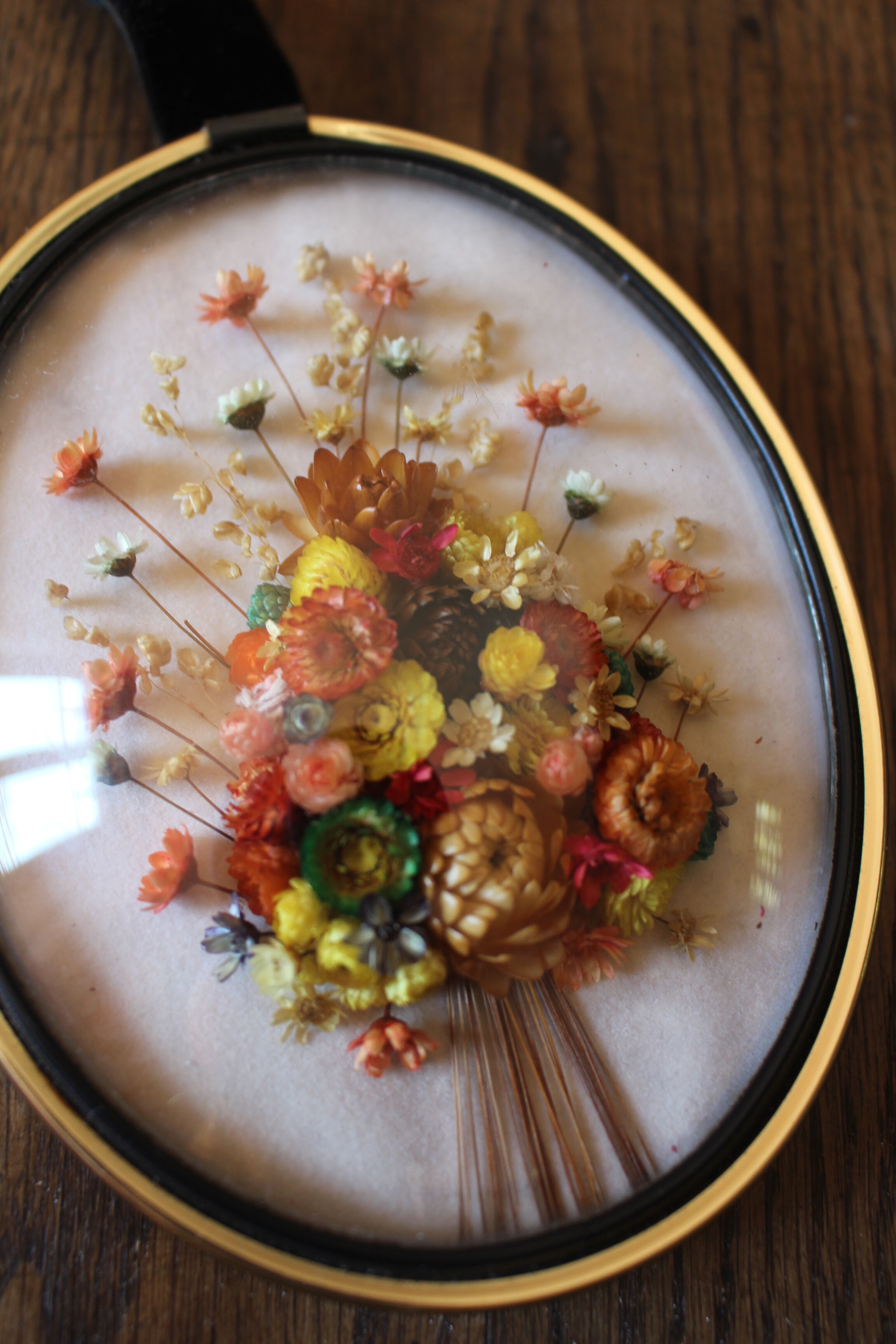 Vintage medallion domed glass dried flowers black gold