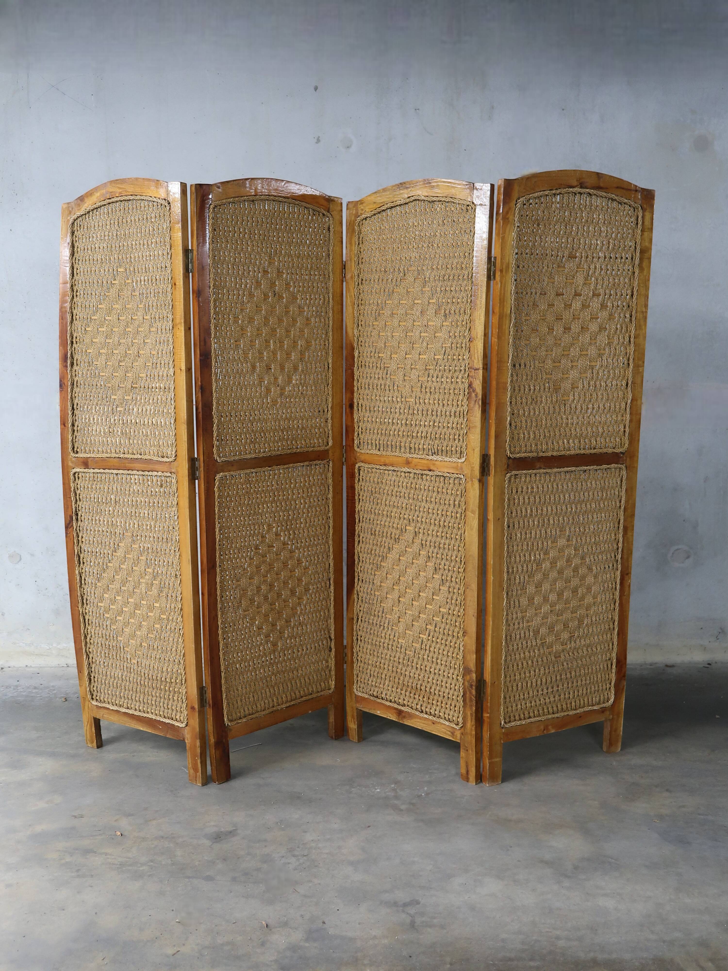 Handcrafted screen in exotic wood and rope.