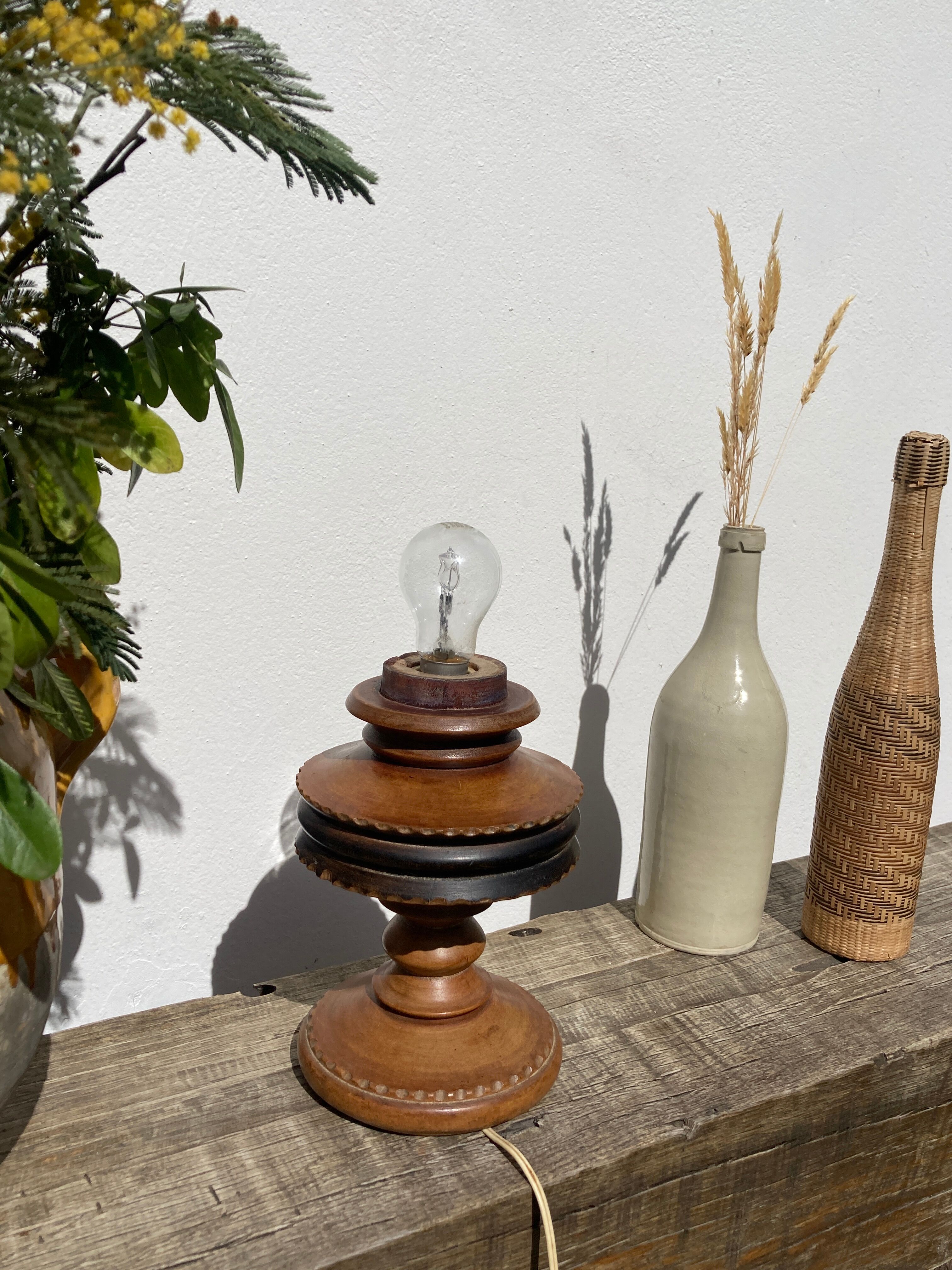 Foot of turned wooden lamp and carved