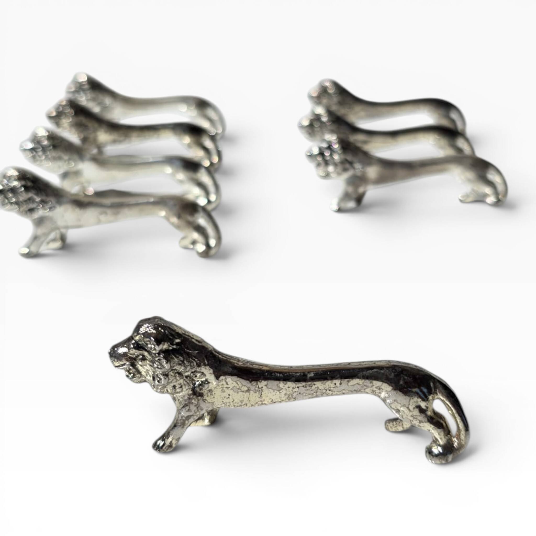 Series of antique knife rests in the shape of a lion, silver-plated metal.
