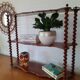 Turned wooden wall shelf
