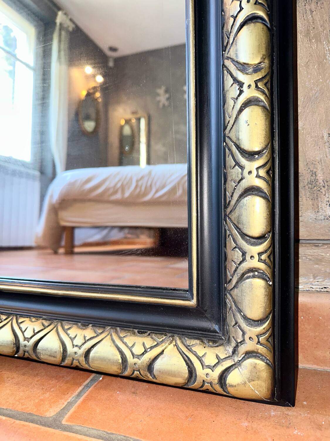 Louis-Philippe black and gold antique mirror from the 19th century