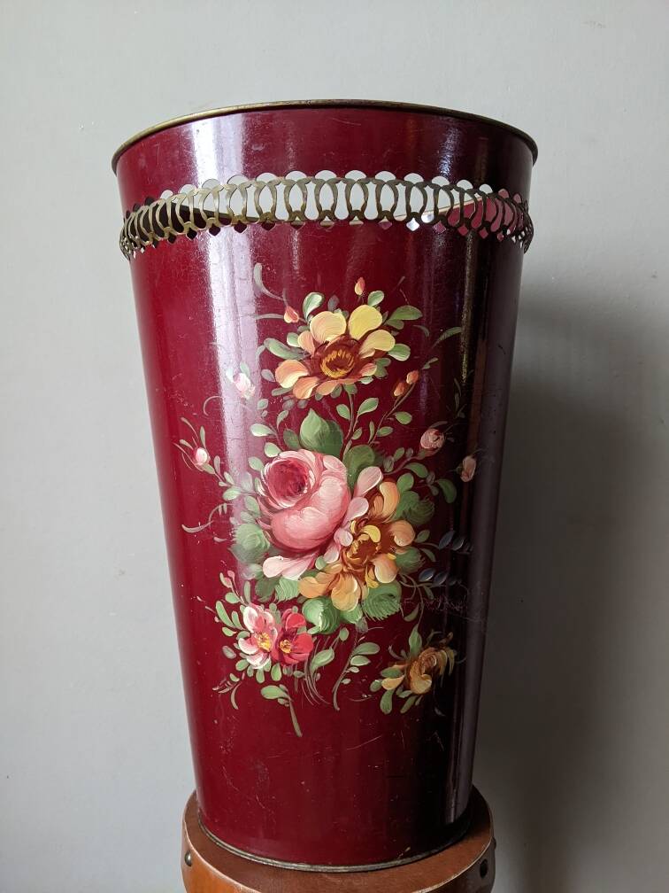 Antique metal umbrella stand with hand-painted floral decor, bohemian countryside