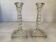 Pair of tall candle holders in the shape of a flower with a square base.
