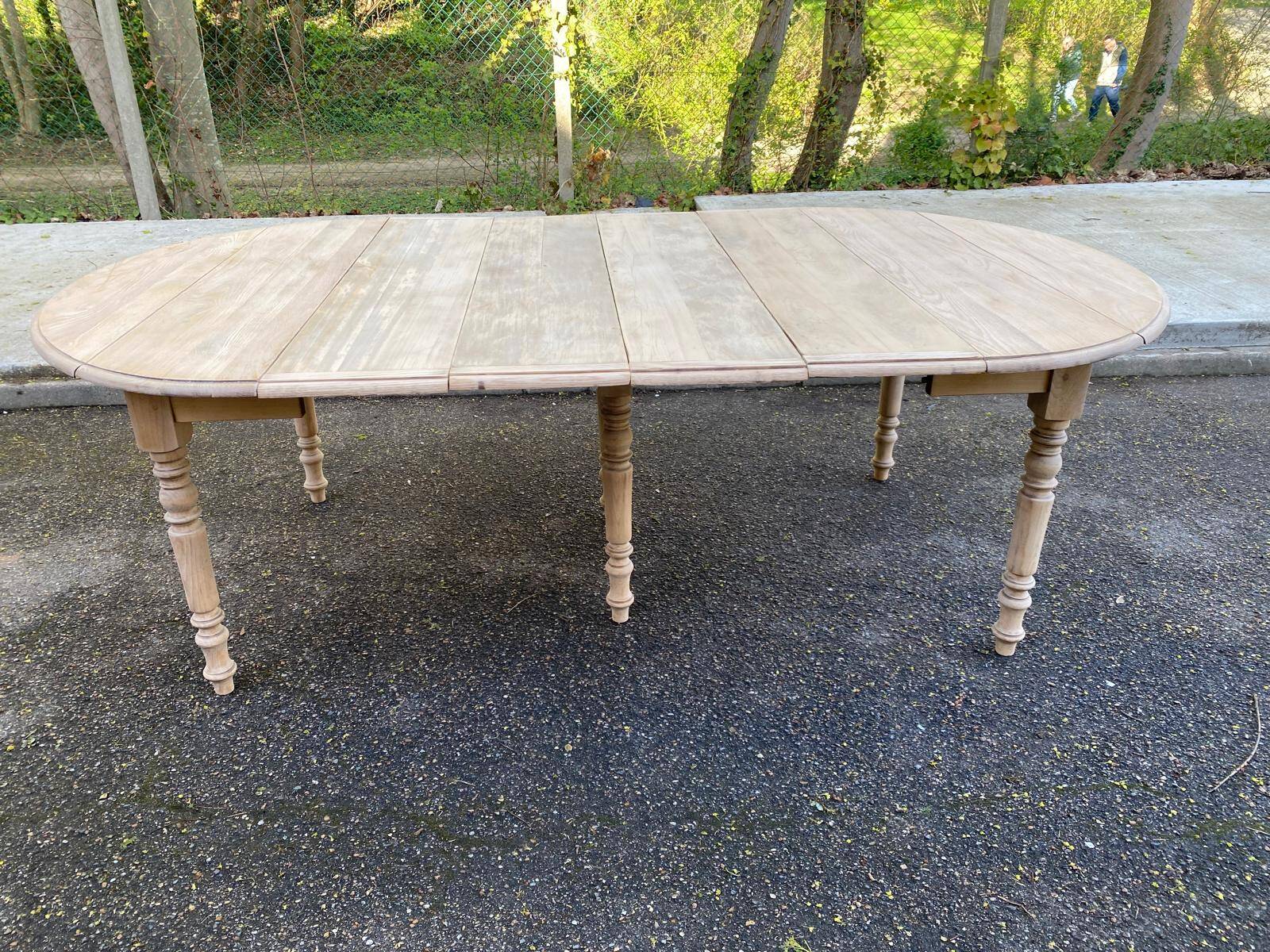 Renovated Louis Philippe round extendable dining table with 4 leaves.
