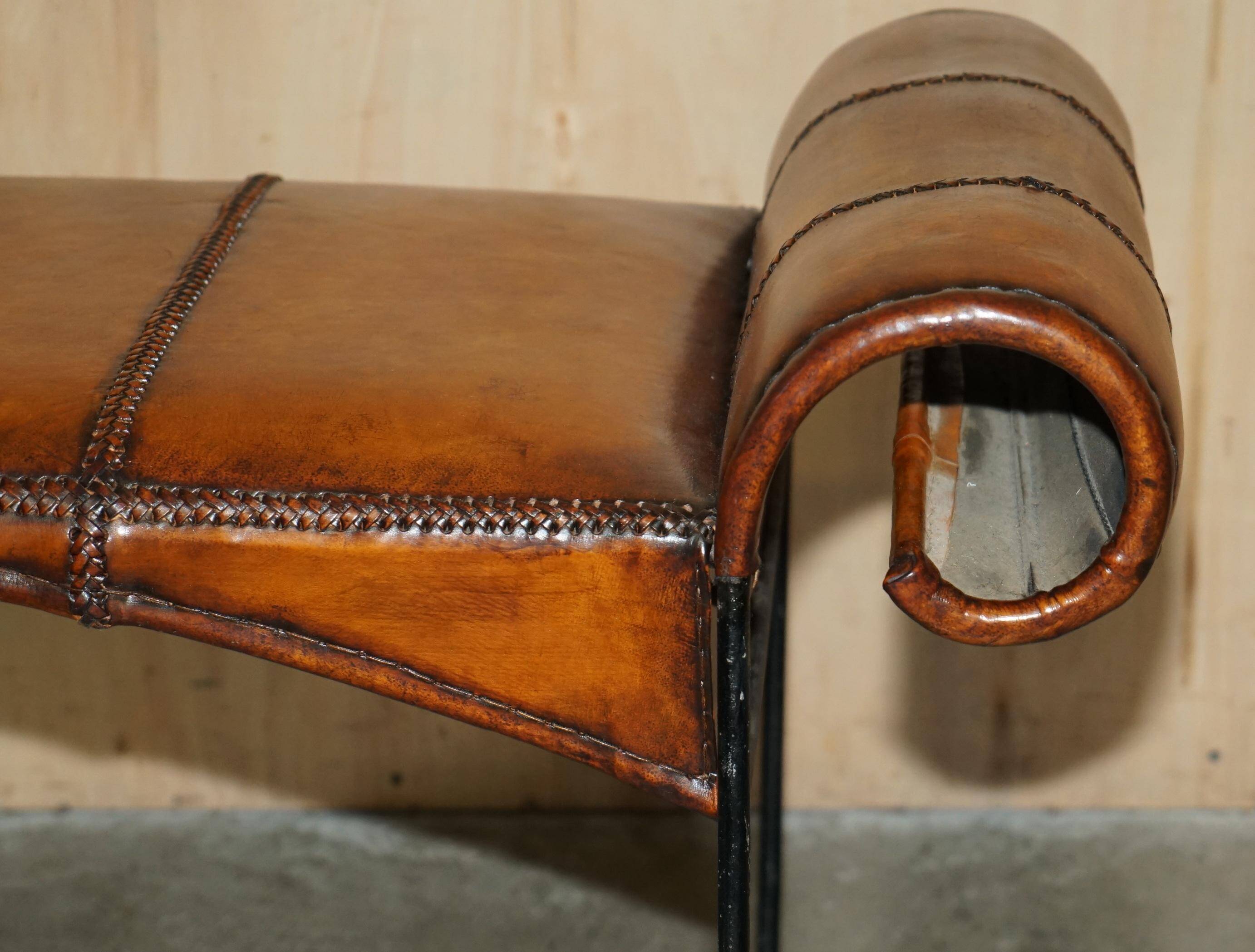 Vintage Spanish window bench in hand-stitched leather and restored iron.