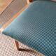 Scandinavian armchairs with green tapered legs.