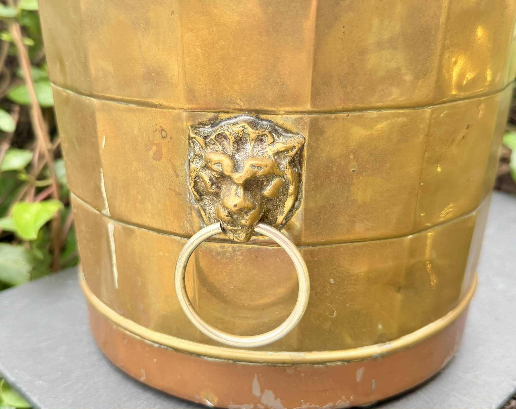 Large brass champagne bucket with baroque lion from the 19th century.