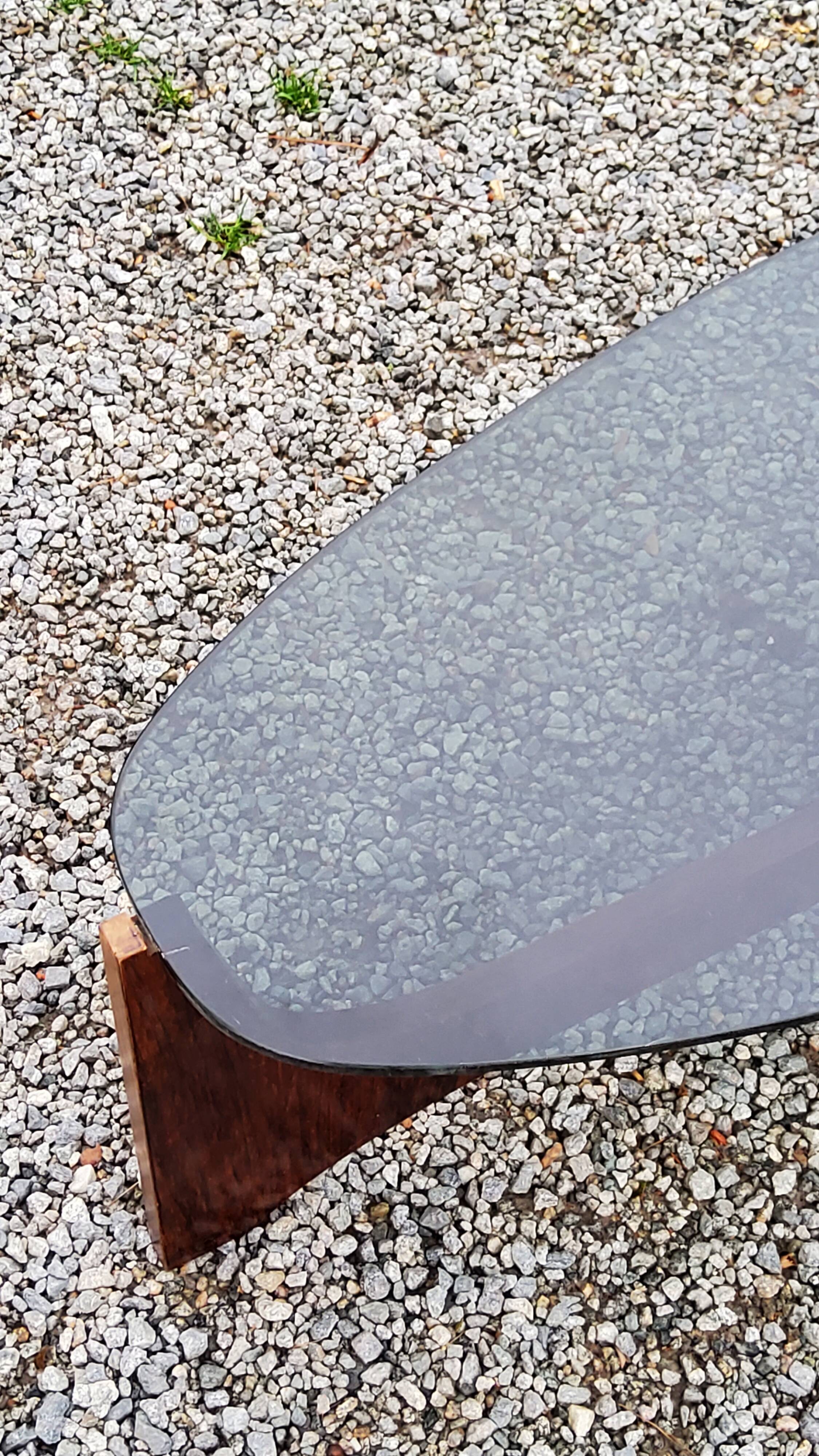 Designer coffee table by Hugues Poignant in rosewood and smoked glass from the 70s