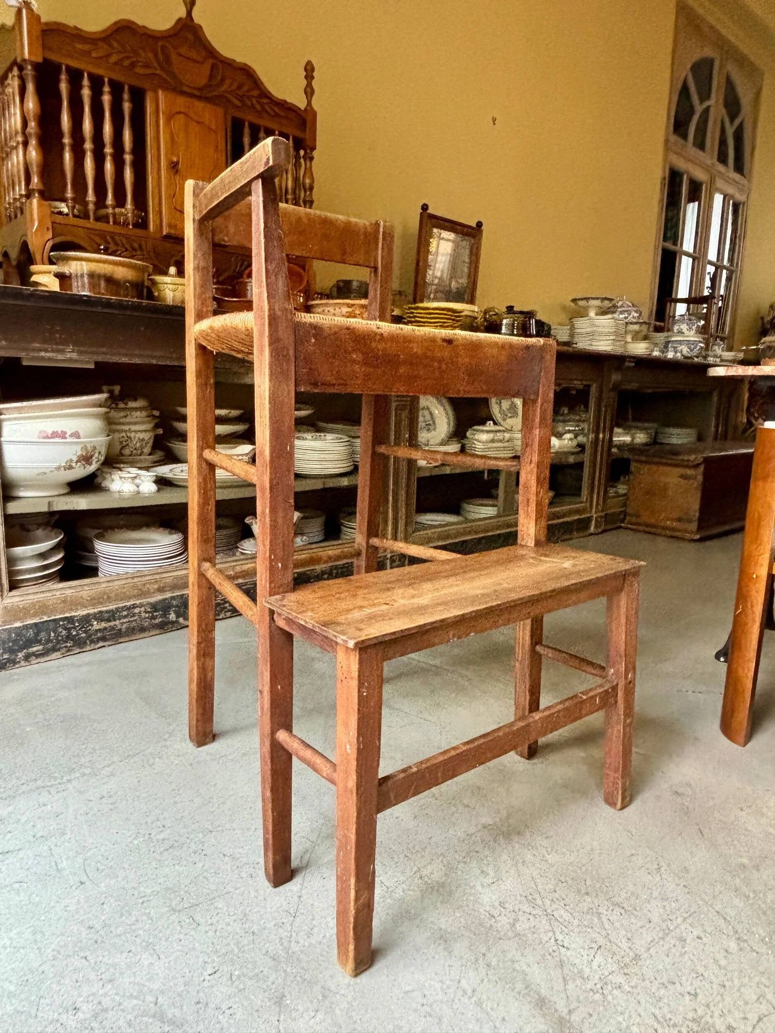 High chair made of wood and straw.