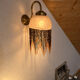 Wall lamp with marbled glass shade and beaded fringe in Art Nouveau style.