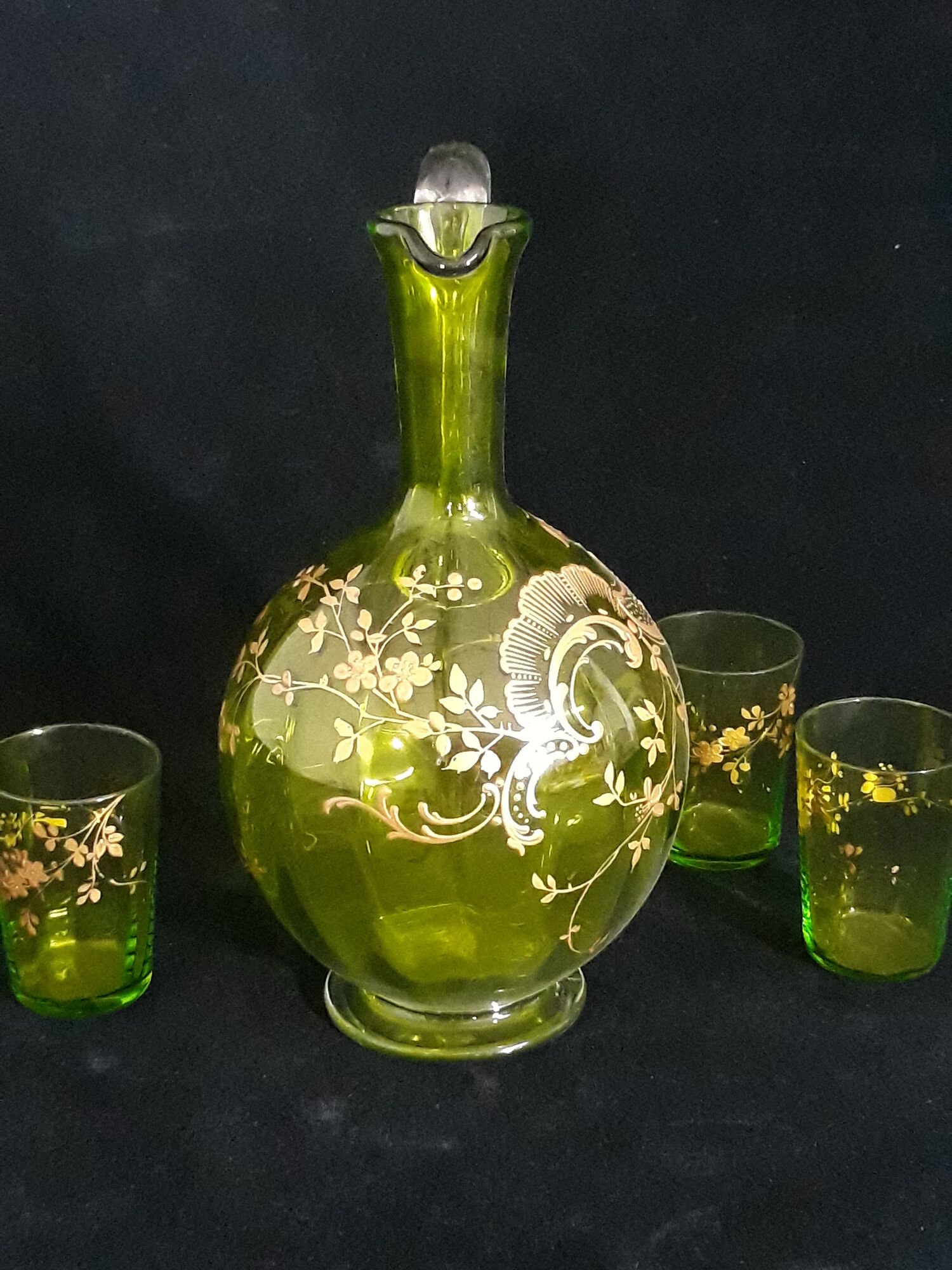 Small carafe and green glass drop glasses with rococo golden emailed decor