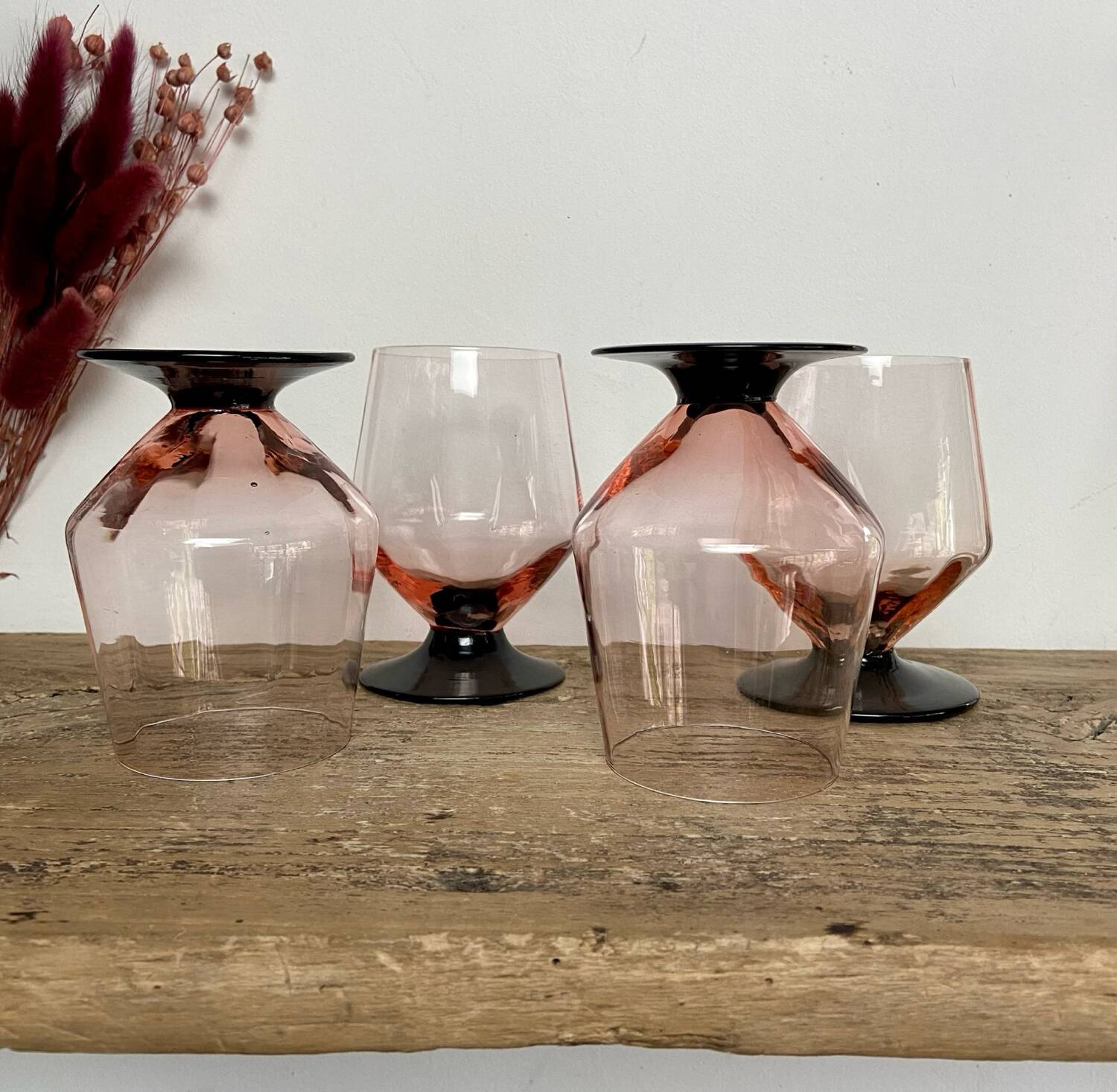 4 pink glasses with black stems