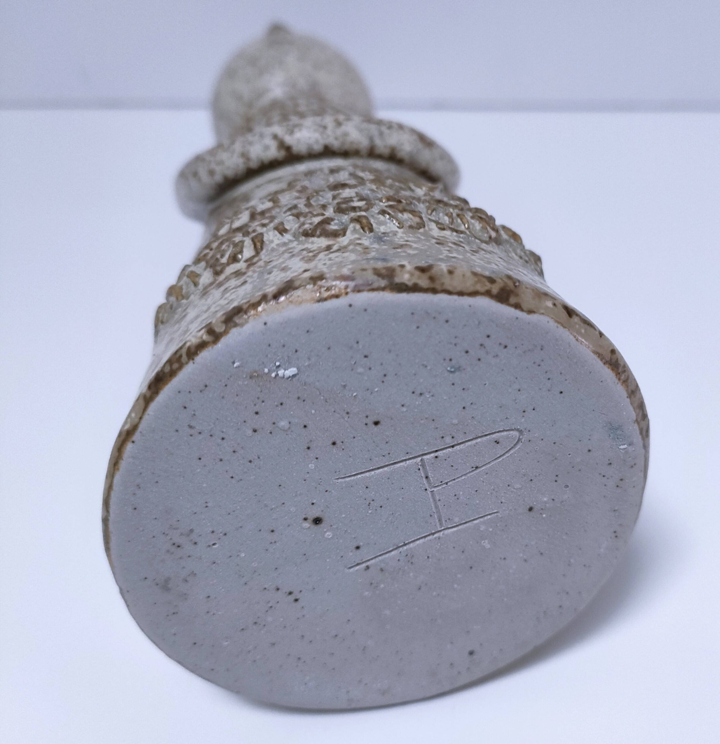 ceramic candle holder with crowned head signed P