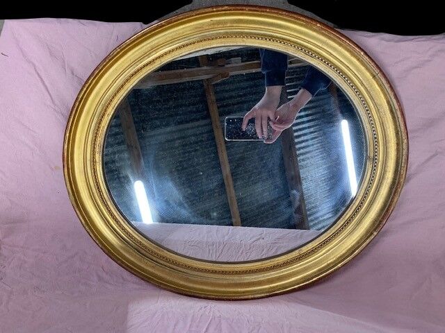 Golden oval mirror