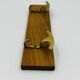 Vintage wall coat rack in brass and wood design.