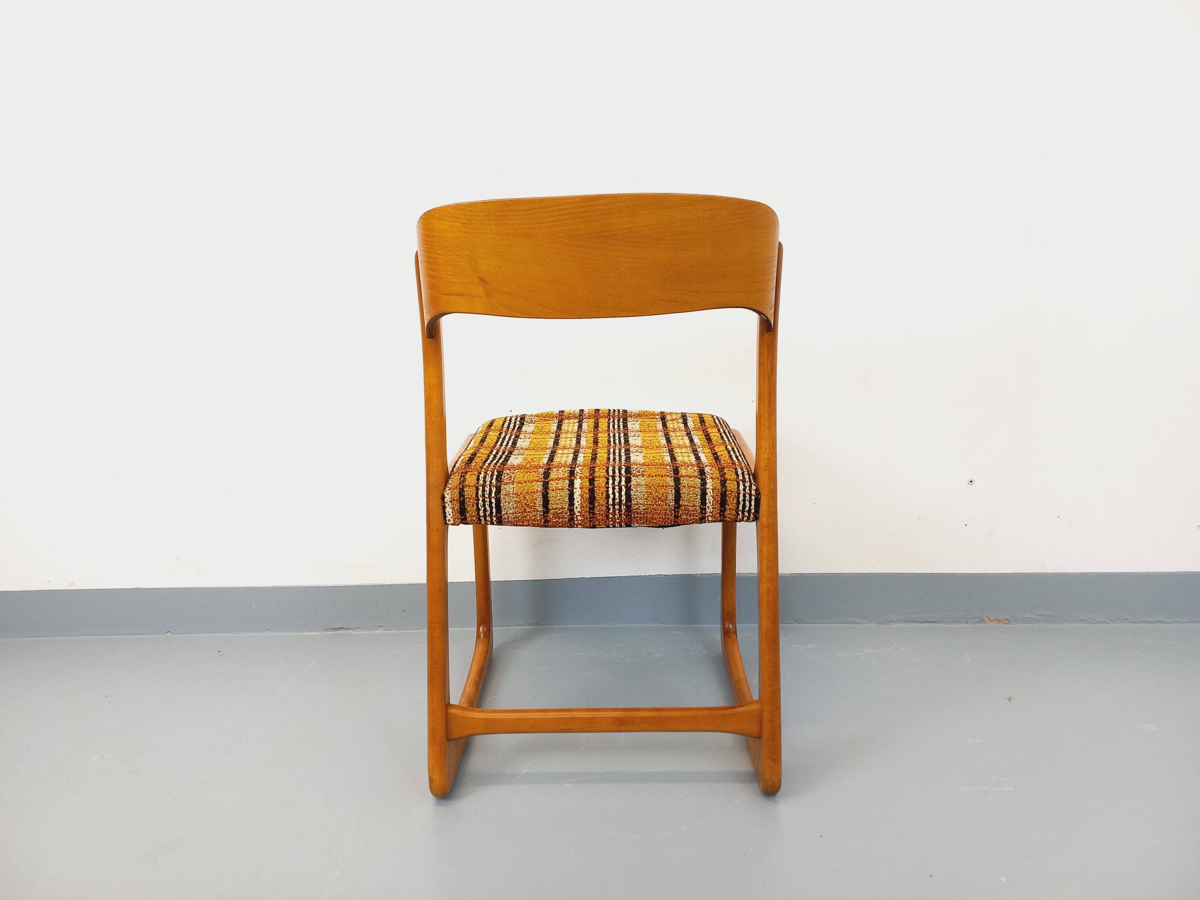 Vintage sled chair by Baumann in wood and wool fabric.
