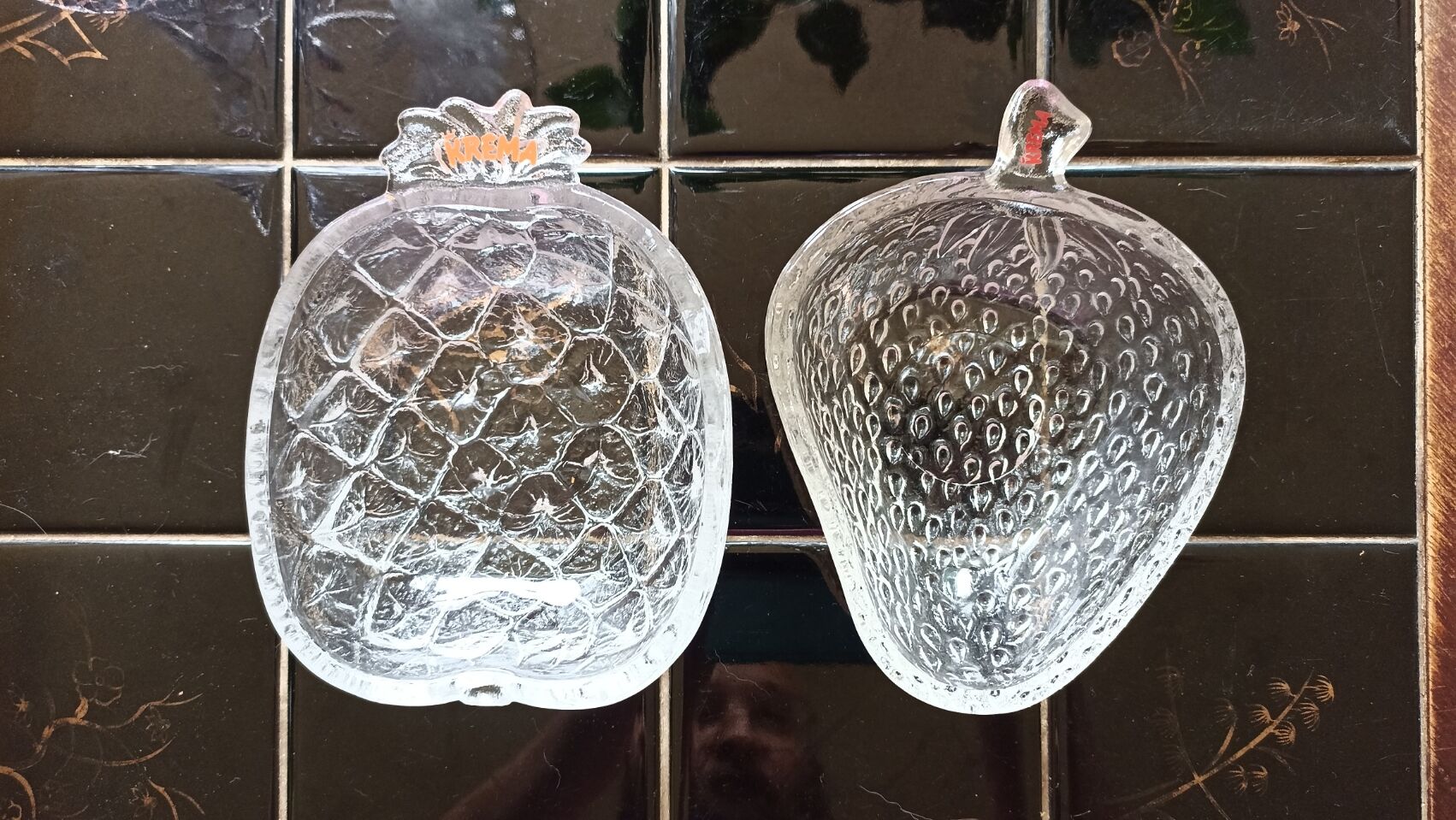 Two molded glass cups in the shape of strawberry and pineapple