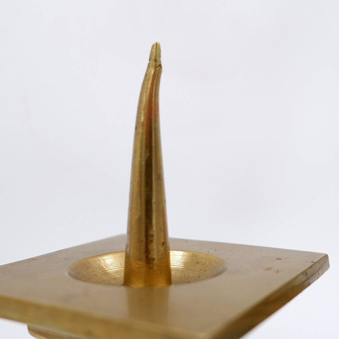 Pair of brass candlesticks decorated with a blue stone inlaid in the center