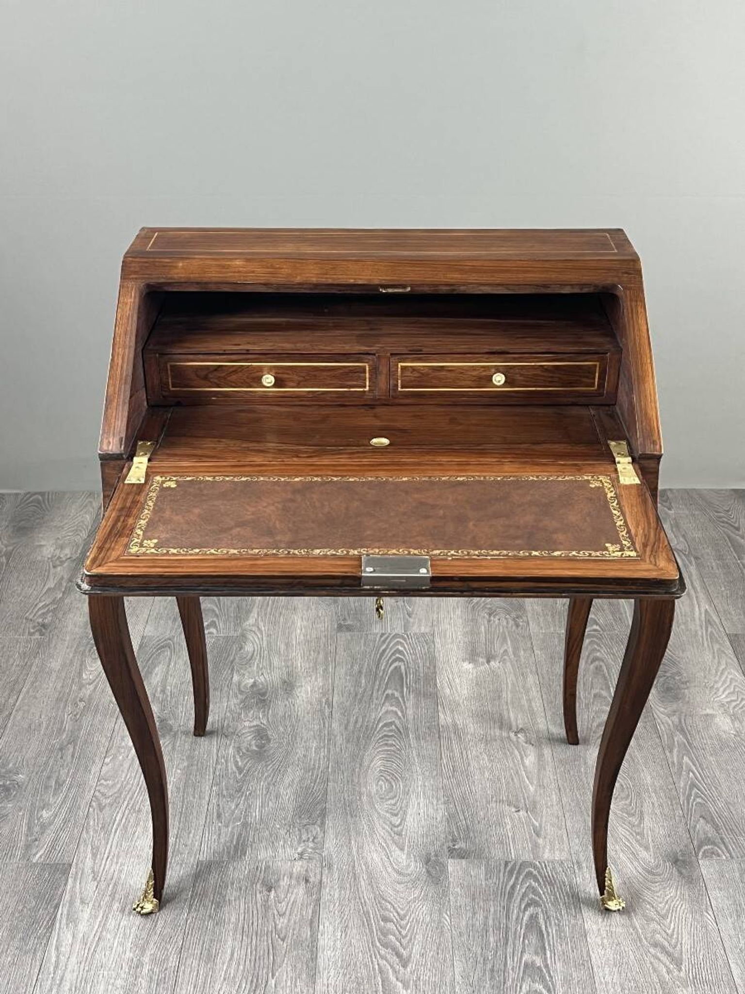 Secretary with a drop-down front in marquetry, Louis XV style, 19th century.