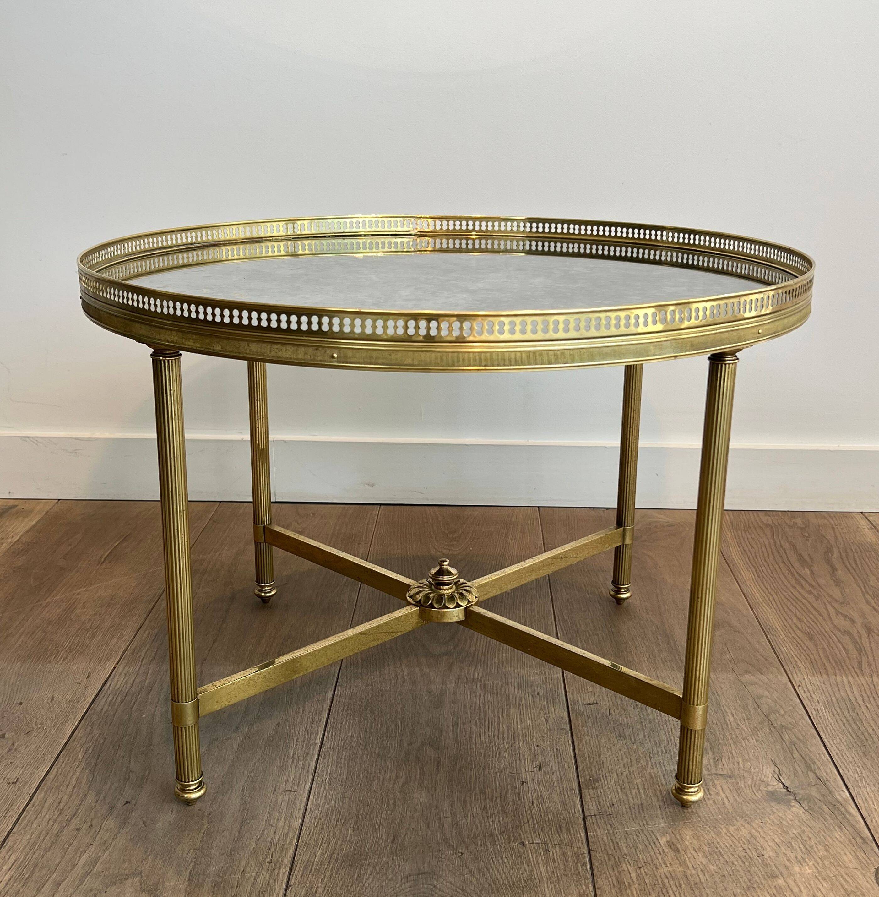 Brass coffee table with a vintage mirror top from the Baguès house.