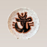 Terracotta plate, Jean Lurçat decorated with a character on a white background.