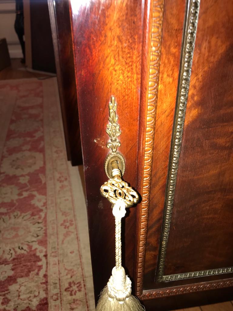 A mahogany buffet varnished with marble and bronze
