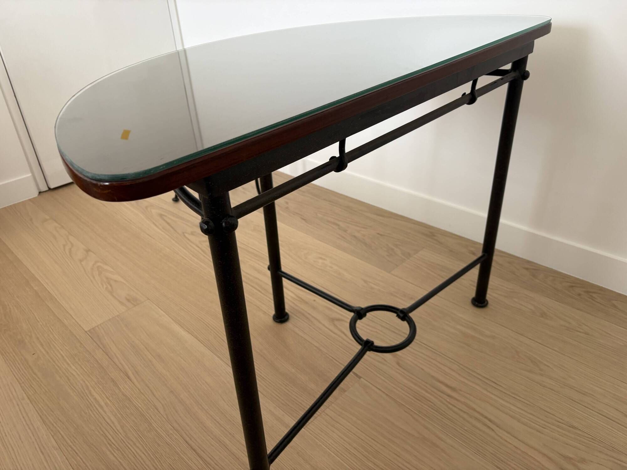 Half-moon console grange in solid cherry wood and wrought iron with a glass top.