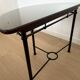 Half-moon console grange in solid cherry wood and wrought iron with a glass top.