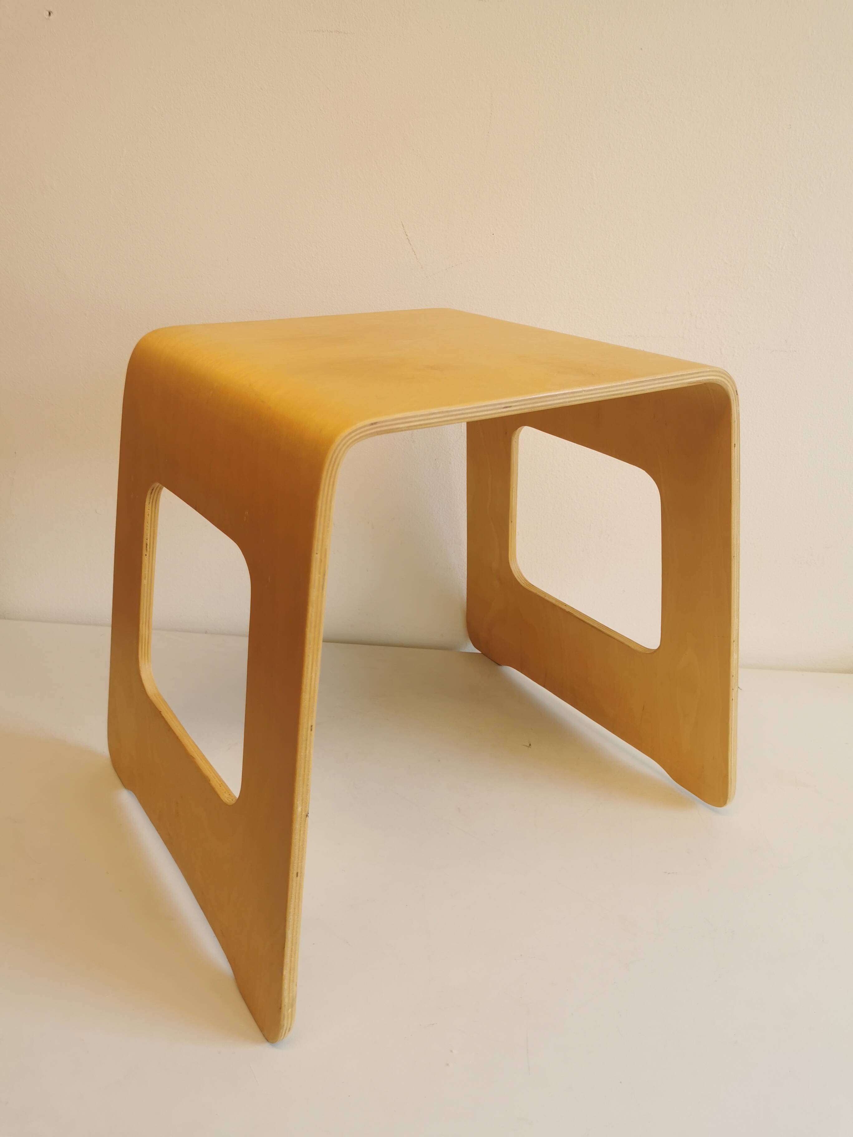Design stool/side table made of curved plywood.