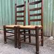 Duo of vintage rustic straw straw chairs in oak.