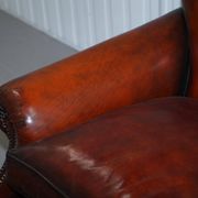 Restored Victorian sofa in leather with claw feet and feather cushions.