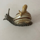 Porcelain figurine snail and its small