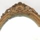 Pair of oval wooden windows with golden patina