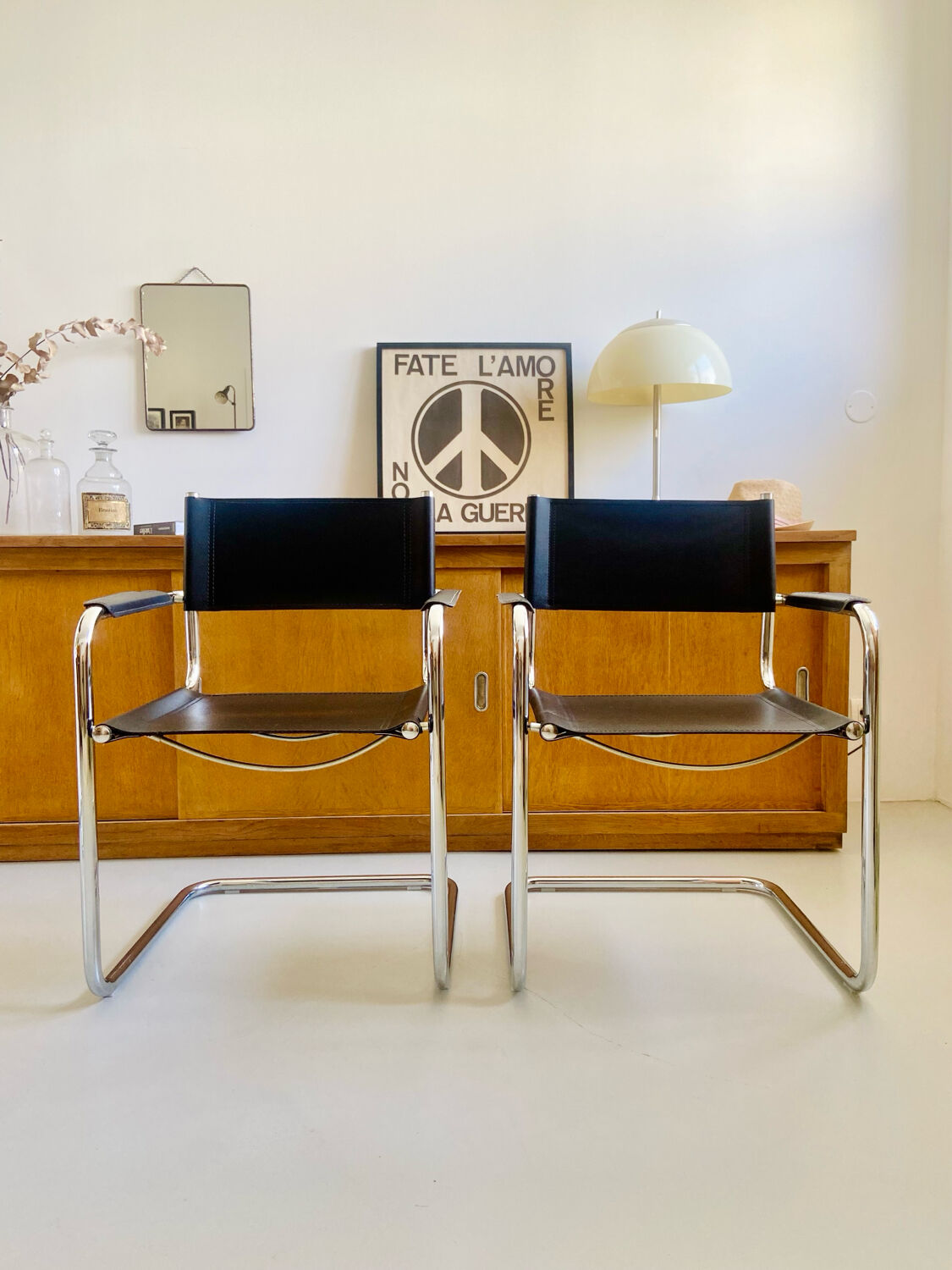 Pair of vintage chrome and black faux leather armchairs