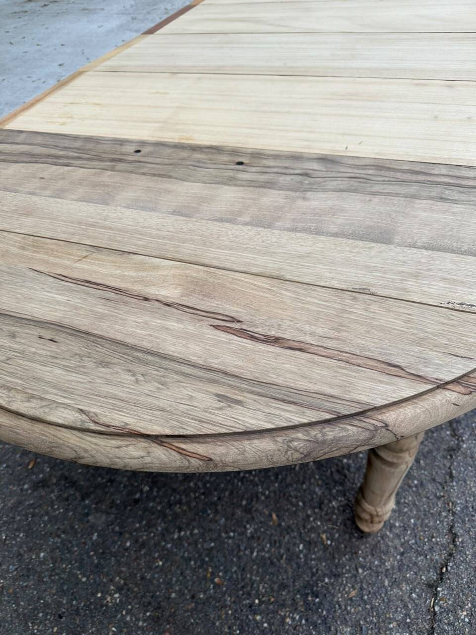 Round extendable dining table with flaps, stripped in raw oak, with 4 extensions.