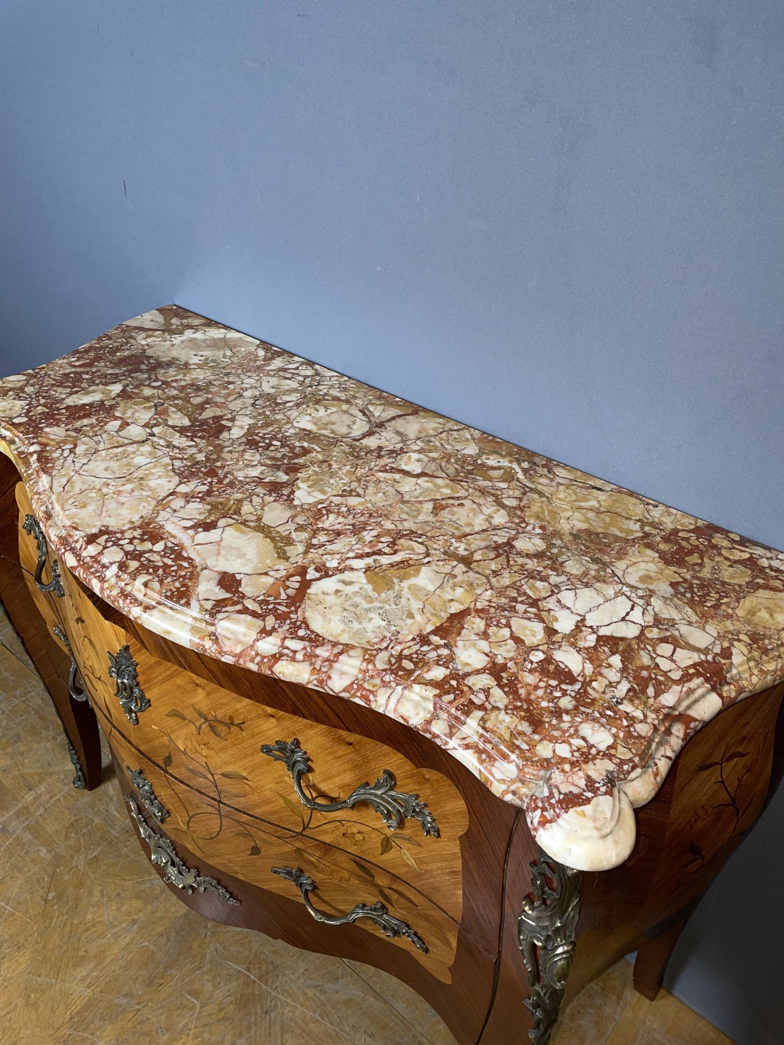Louis XV style commode with floral marquetry decoration.