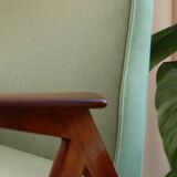 Vintage armchair in mint green wool, mid-century modern design.