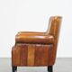 Cognac-colored sheep leather armchair finished with decorative nails