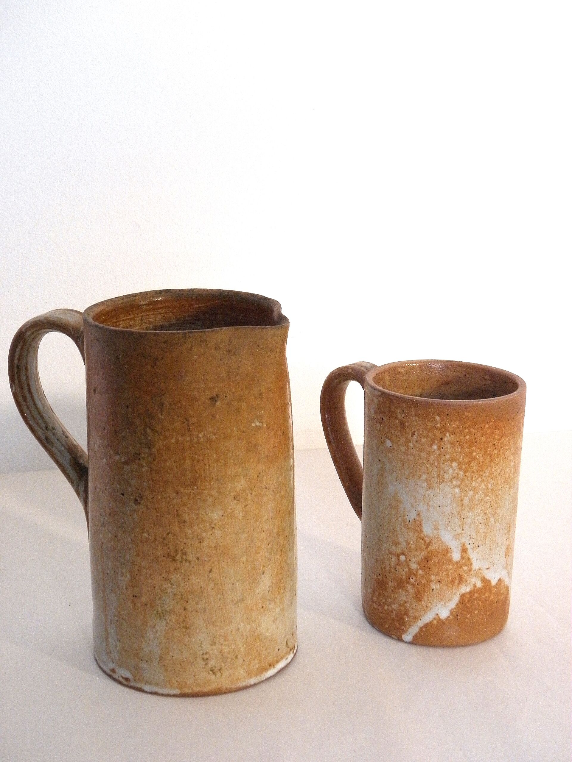 Decanter and enamelled stoneware mugs
