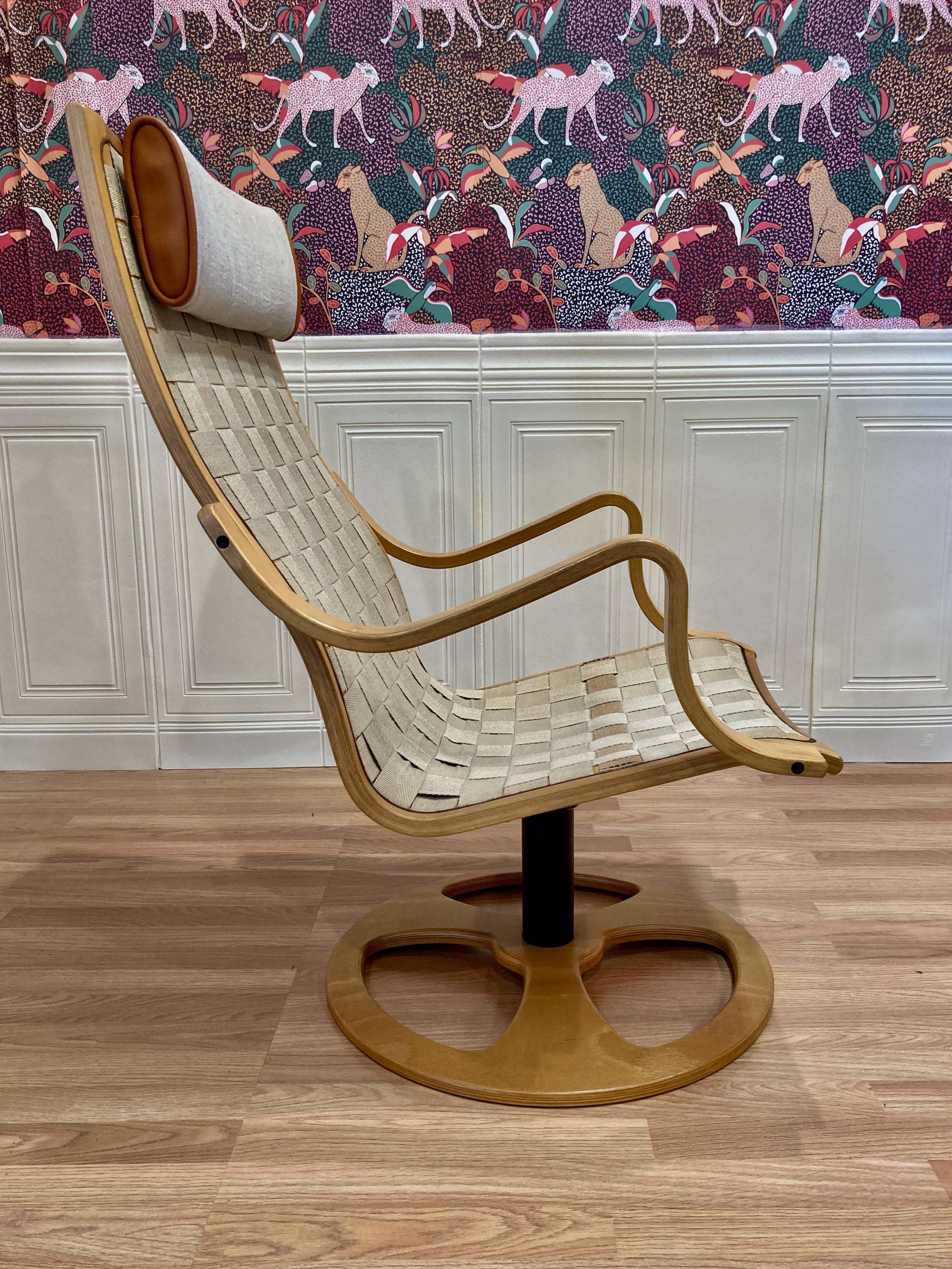 Swivel armchair and its ottoman in 1960s Scandinavian design.