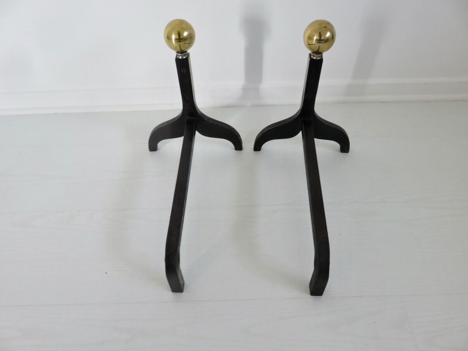 Pair of modernist steel and brass andirons