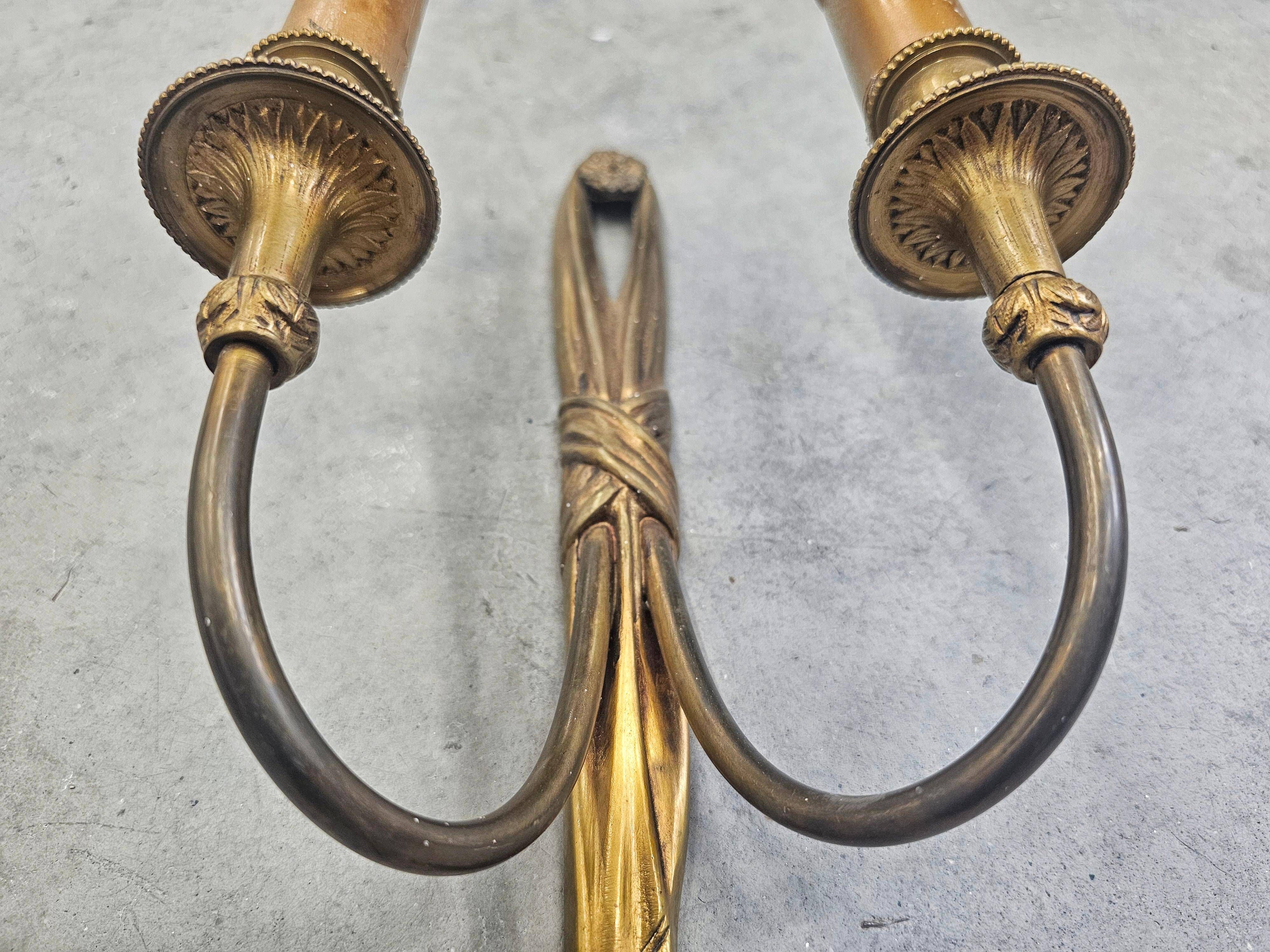 Pair of Louis XVI style bronze wall sconces with bow and tassel, 1940s.