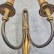 Pair of Louis XVI style bronze wall sconces with bow and tassel, 1940s.