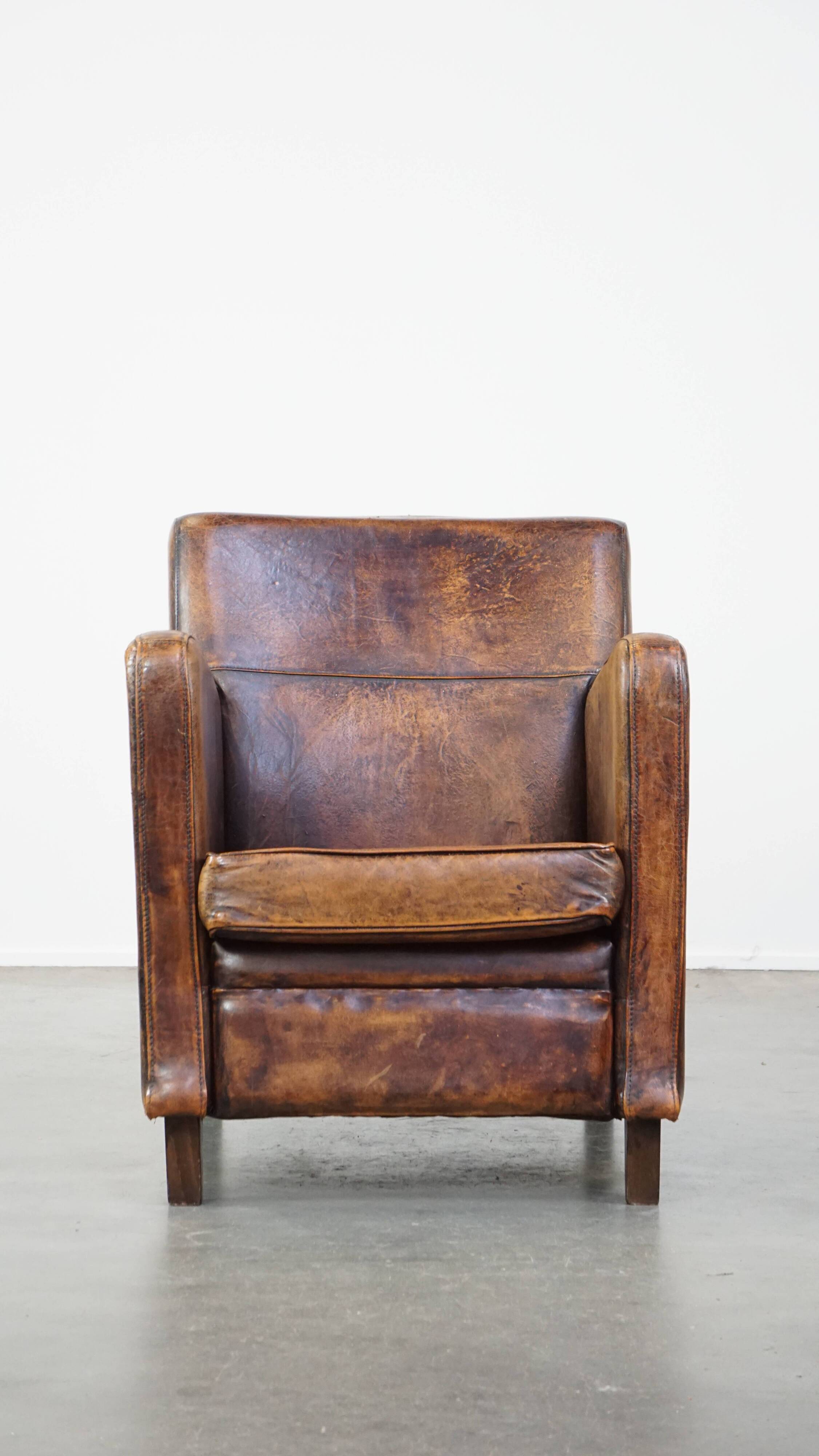 Dark brown design armchair made of sheepskin leather