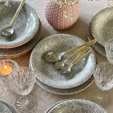 12 speckled ceramic plates.