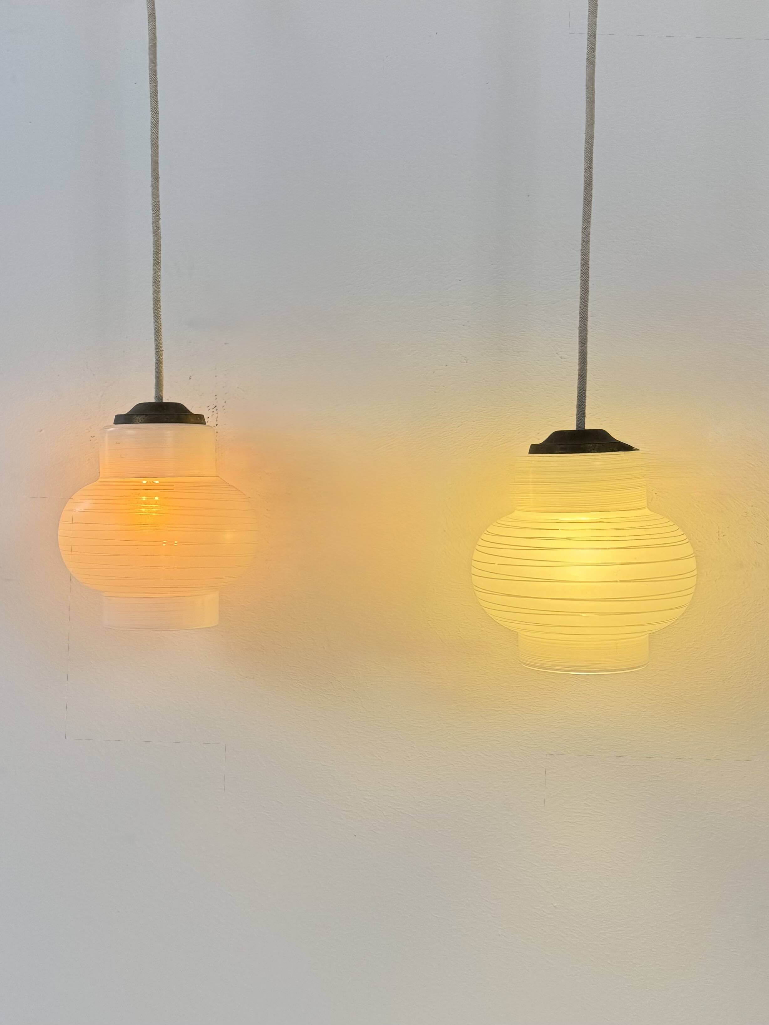 Pair of vintage pendant lights, blown white glass, France, 1970.