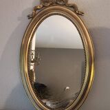 Miroir ovale à noeud doré  en bois